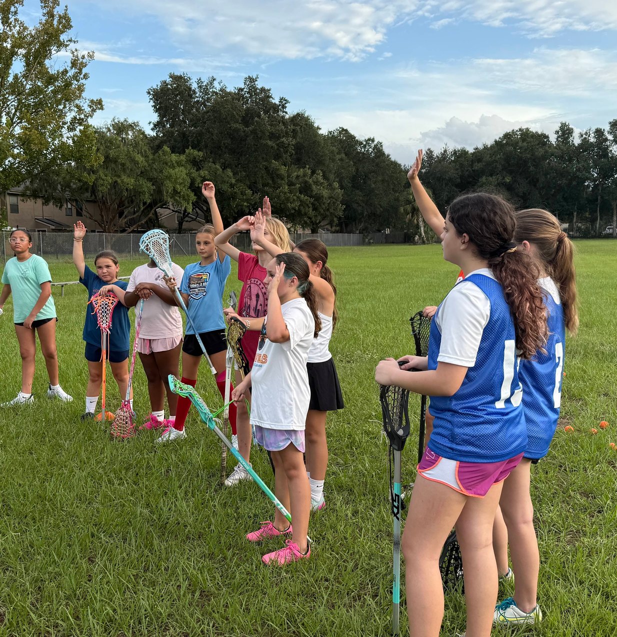 Girls lacrosse players fighting for possession