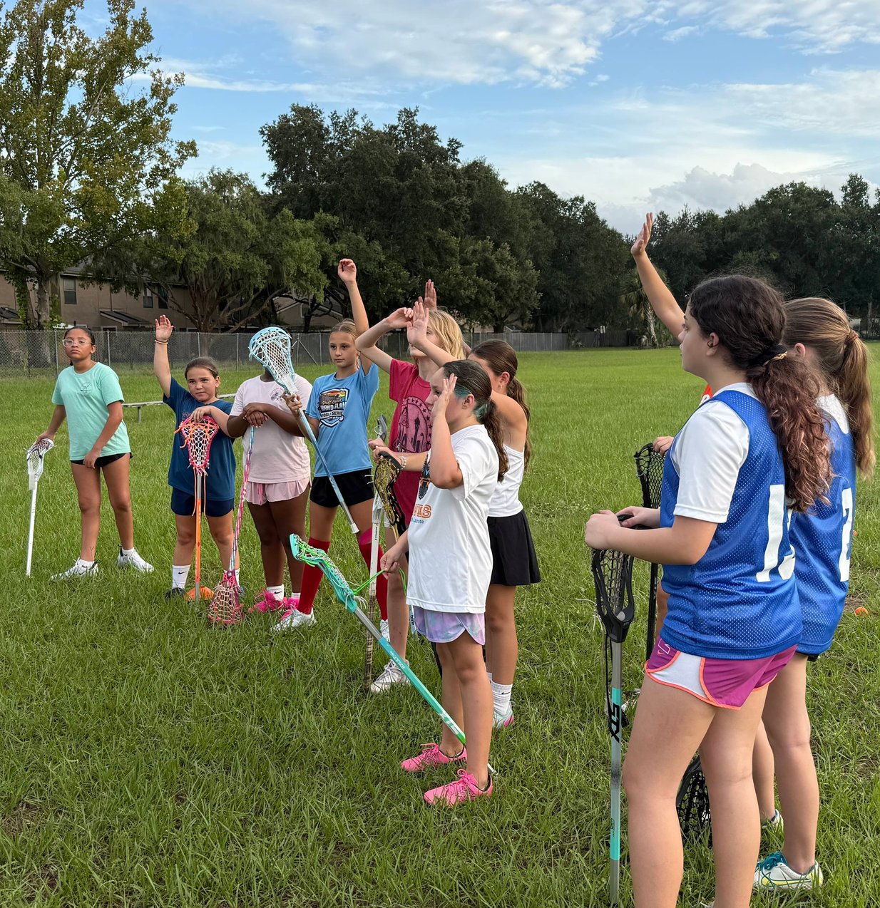 Girls lacrosse players fighting for possession